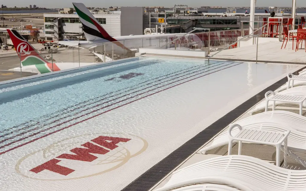 Scenic view of TWA Hotel rooftop pool with airplanes at JFK Airport, New York.