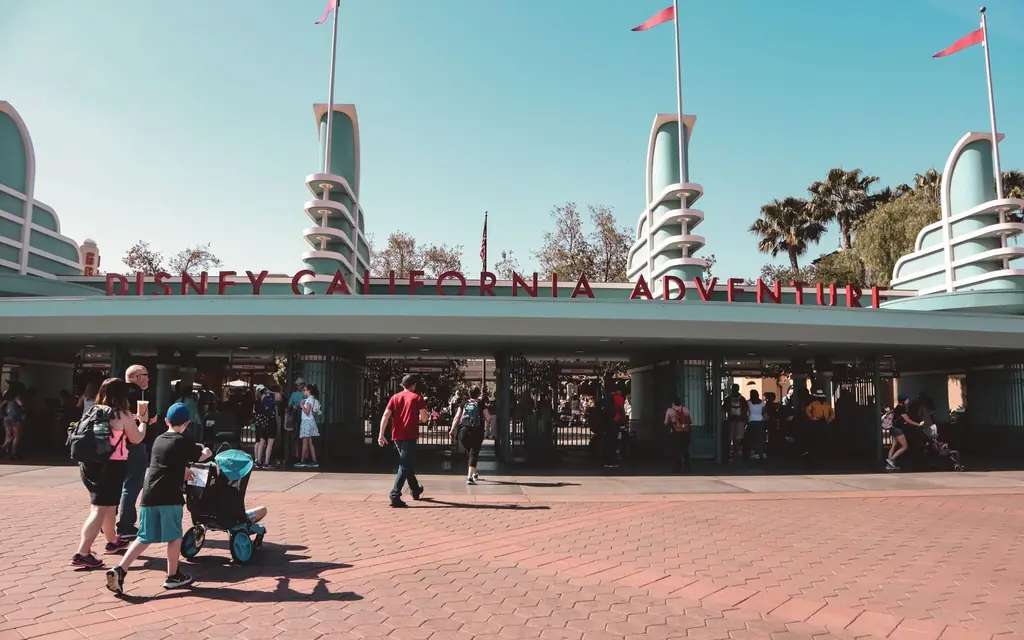 Visitors at Disney California Adventure Park entrance in Anaheim, a popular family destination.