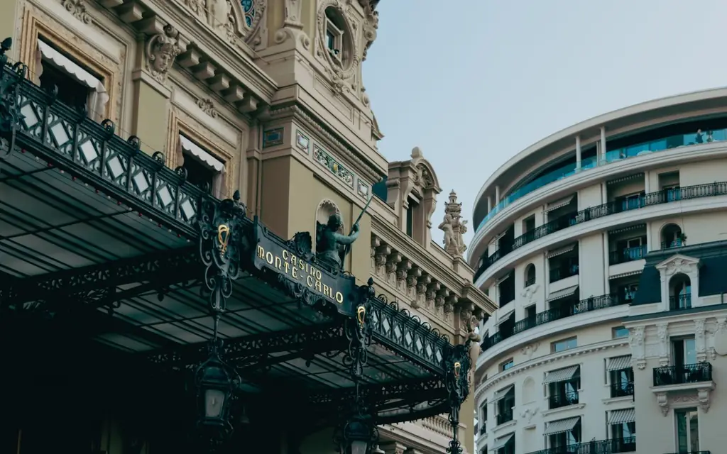 Elegant architecture of Monte Carlo Casino and nearby building in sunny Monaco.
